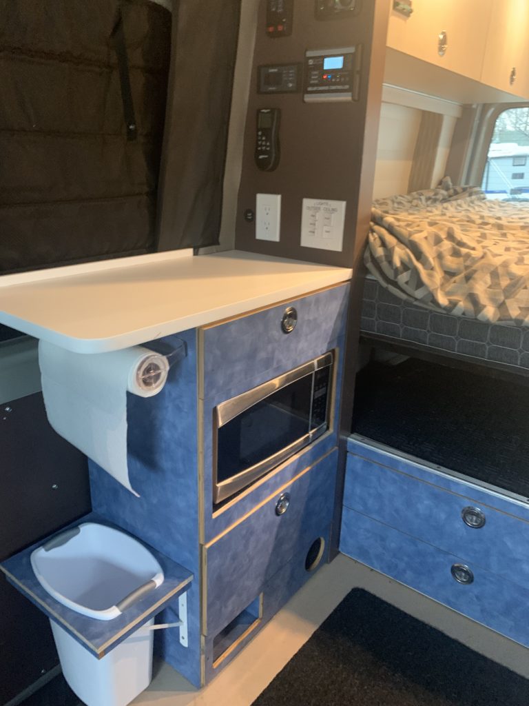 The full kitchen features plenty of counter space and a microwave.